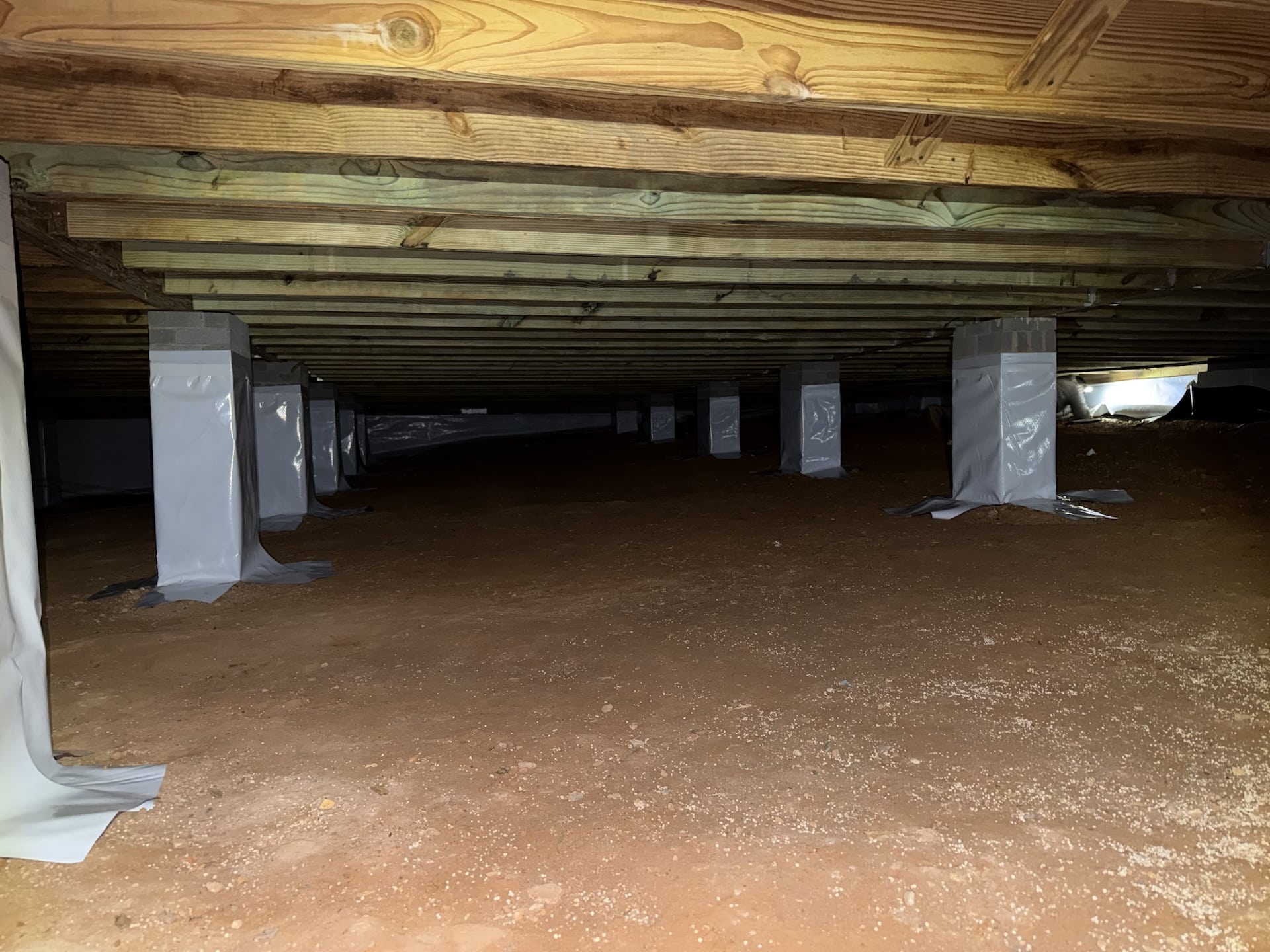 crawl space of a home with a dirt floor