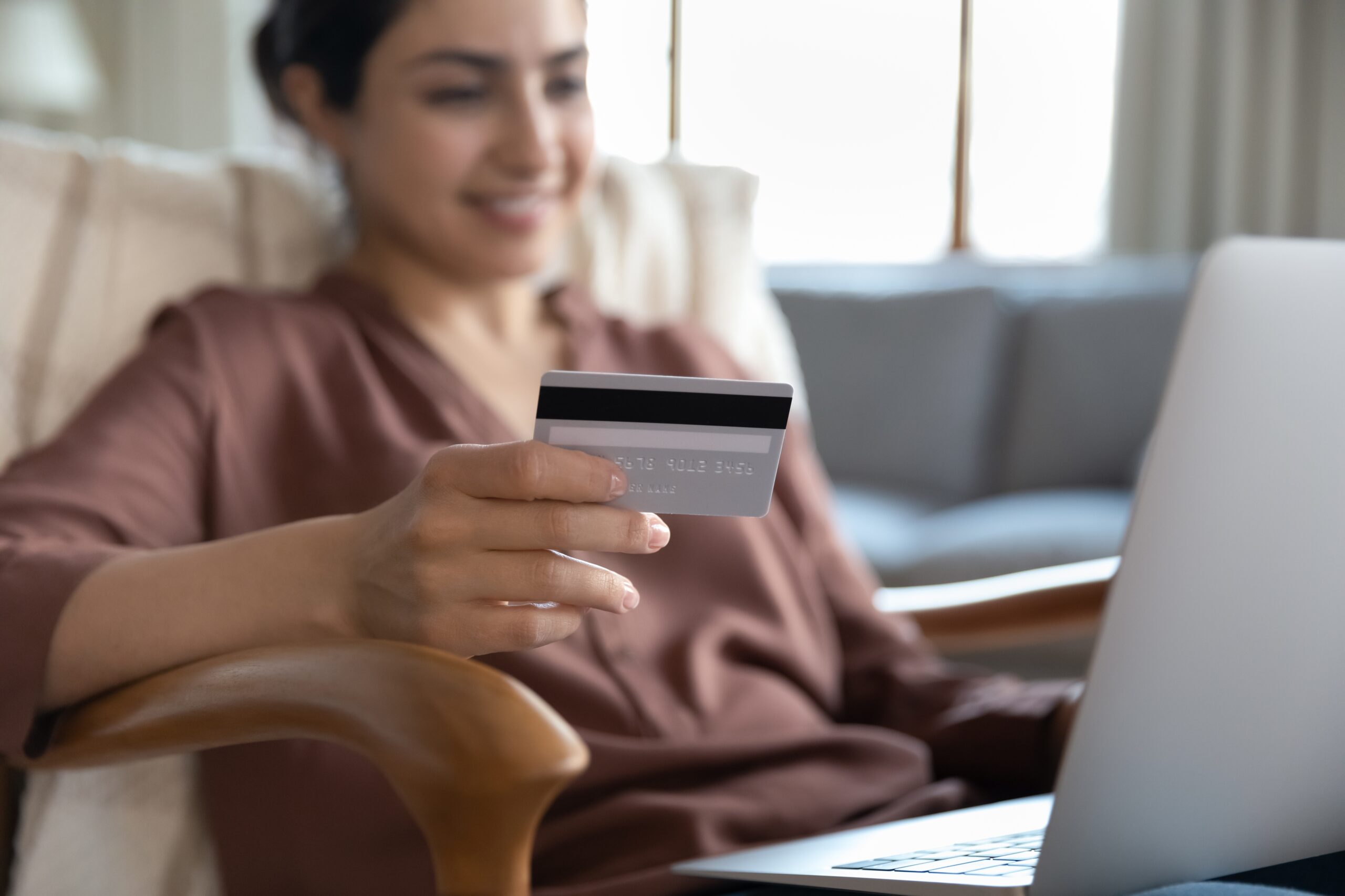 woman using a credit card to pay online